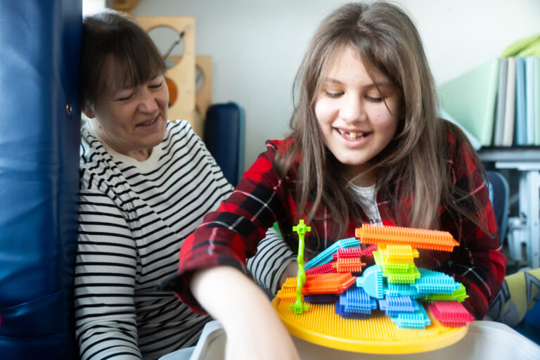 A girl and a teacher playing