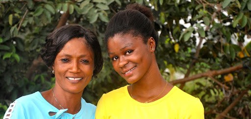 Patricia, a girl in Nigeria, with her BLOOM+ facilitator, Glory.