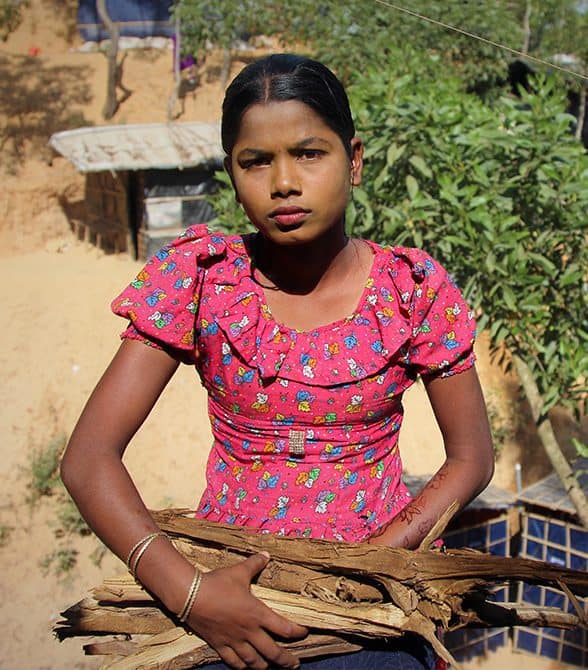 Girl carrying wood