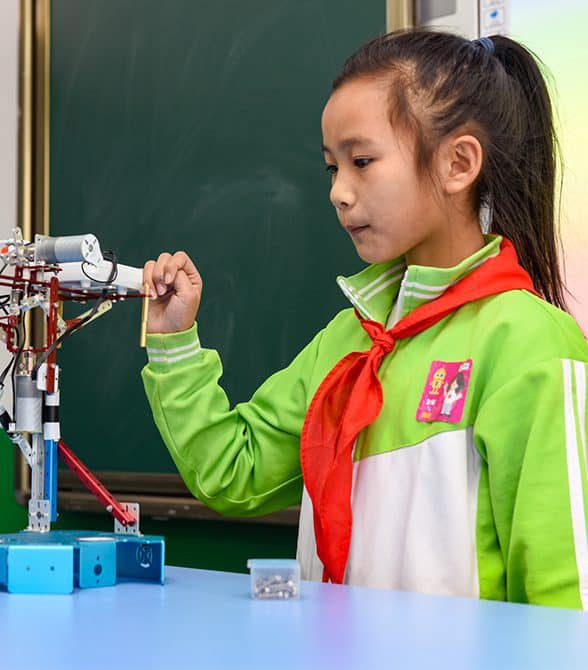 Girl in China STEM Program with Robot