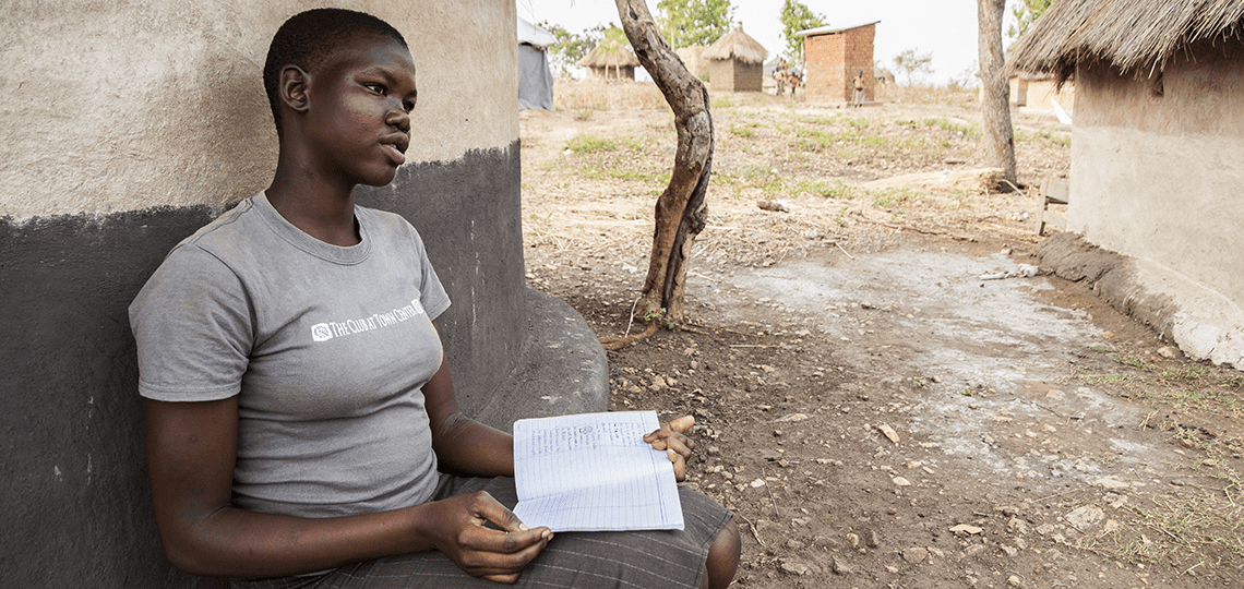 Photo of refugee girl Stella in front of home