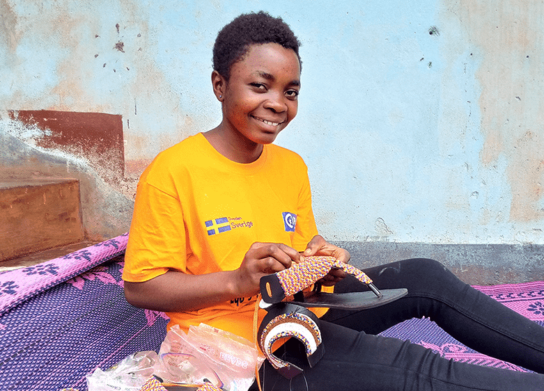 Yeluma, a brave young woman who survived war in Cameroon, is an entrepreneur and bead artist