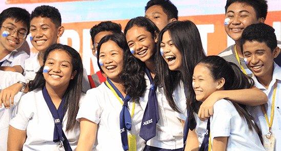 Happy group of girls and boys youth at a Plan gender equality event