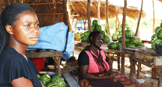 Gladys works at her mother's roadside stand in Zambia to earn money for food