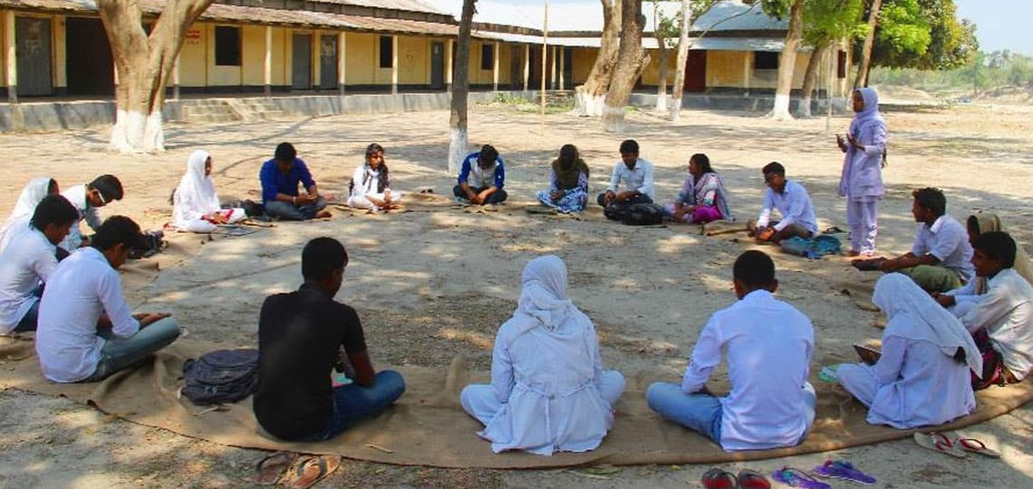 Bangladesh youth sit in a circle