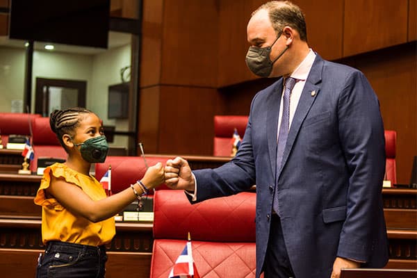 Abigail is a 14-year-old girl in the Dominican Republic with Senator José del Castillo Saviñon for International Day of the Girl