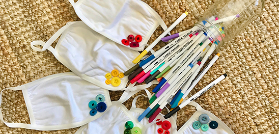 Handmade COVID 19 cloth masks with buttons and markers from Jia's Etsy shop that raises money for girls' rights