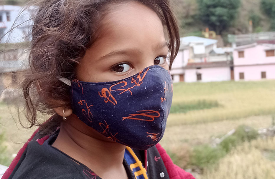 4 Ways to protect children in crisis like this girl wearing a mask to protect her from Covid 19