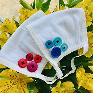 Handmade COVID 19 cloth masks with buttons, made by Jia, a 16 year old teen raising money to support girls’ rights