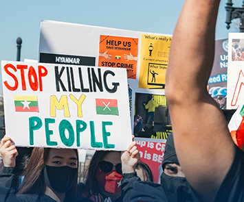 Myanmar protesters with signs like Stop Killing My People