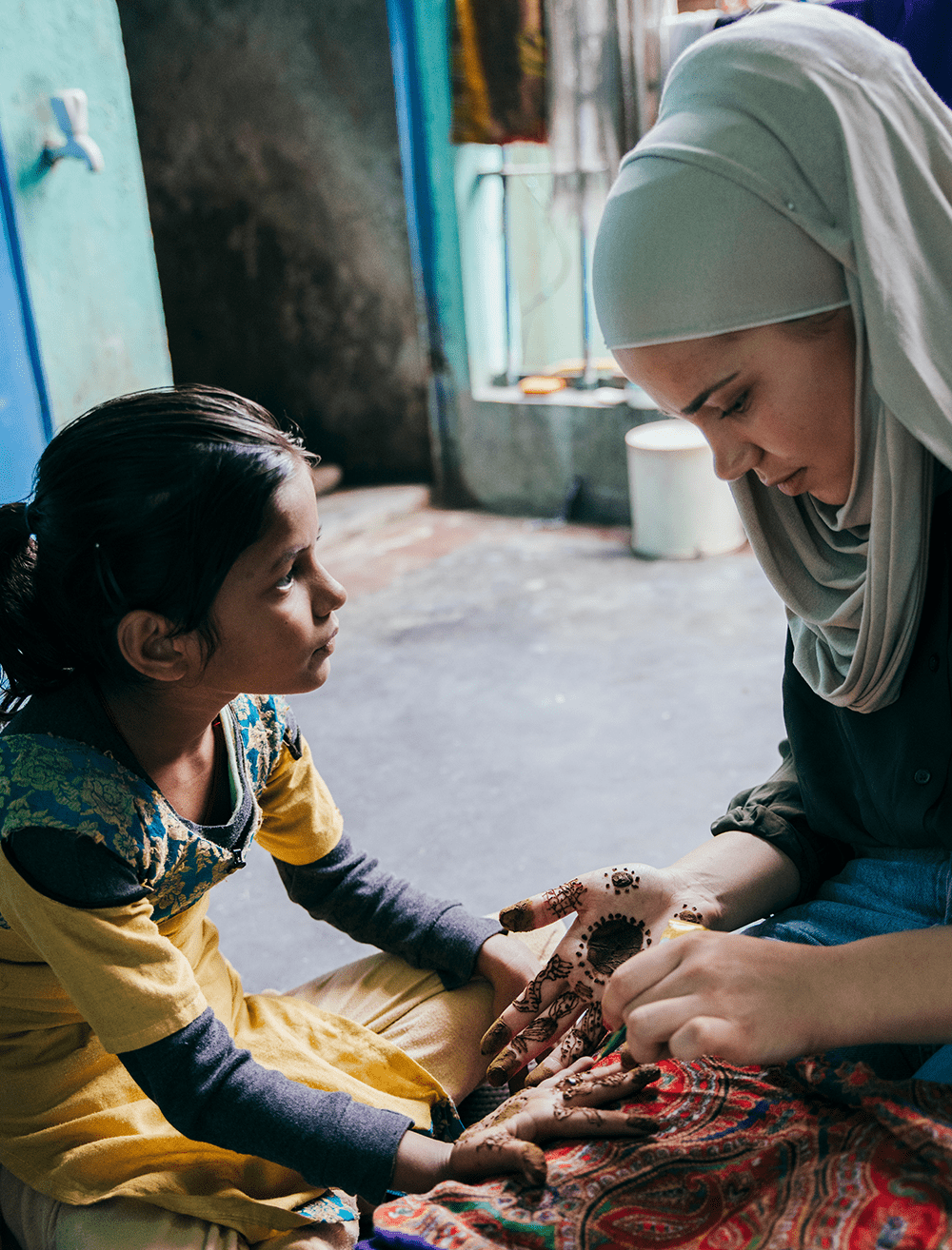 Priya, age 8, lives in Dehli, India, pictured here getting henna (Indian hand art)