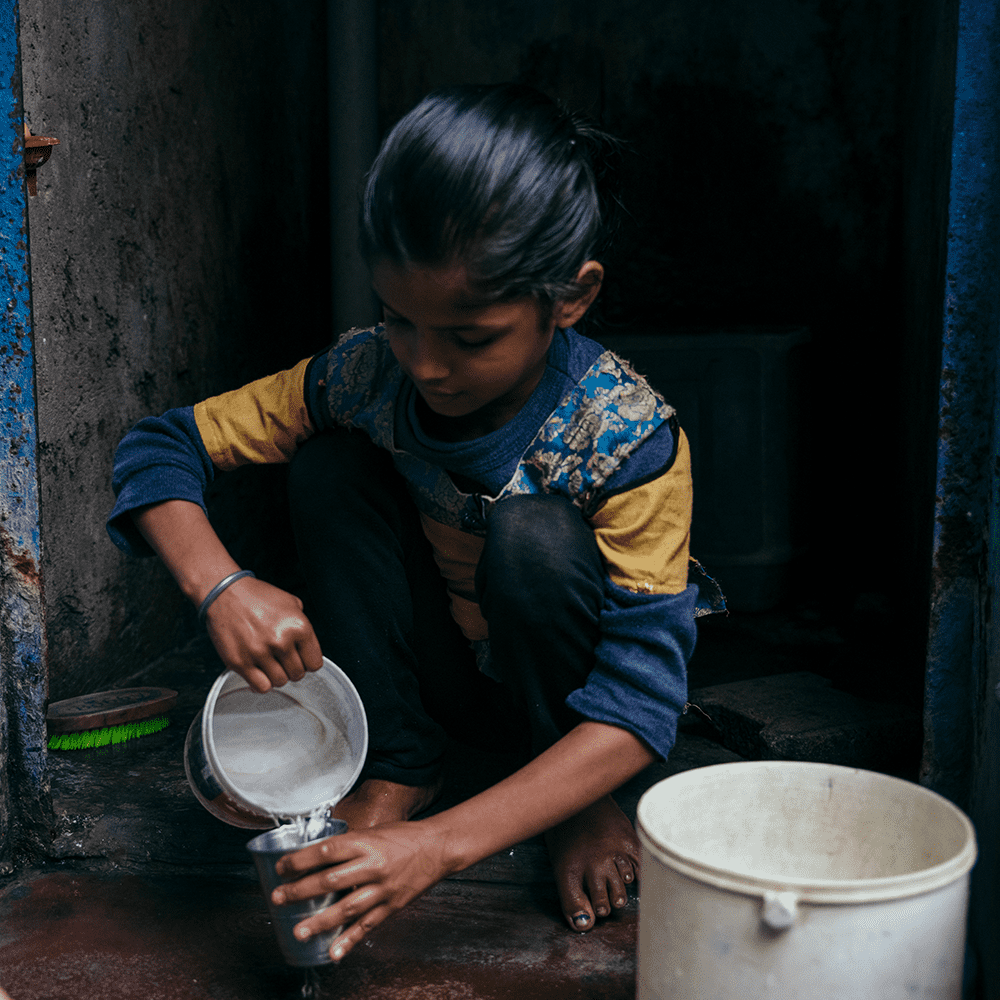 Priya, age 8, lives in Dehli, India, pictured here pouring water