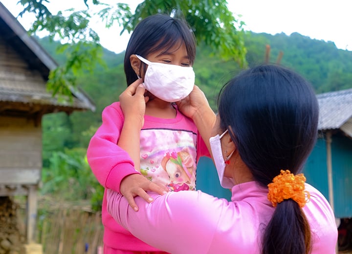 Young Girl With Mask And Mother