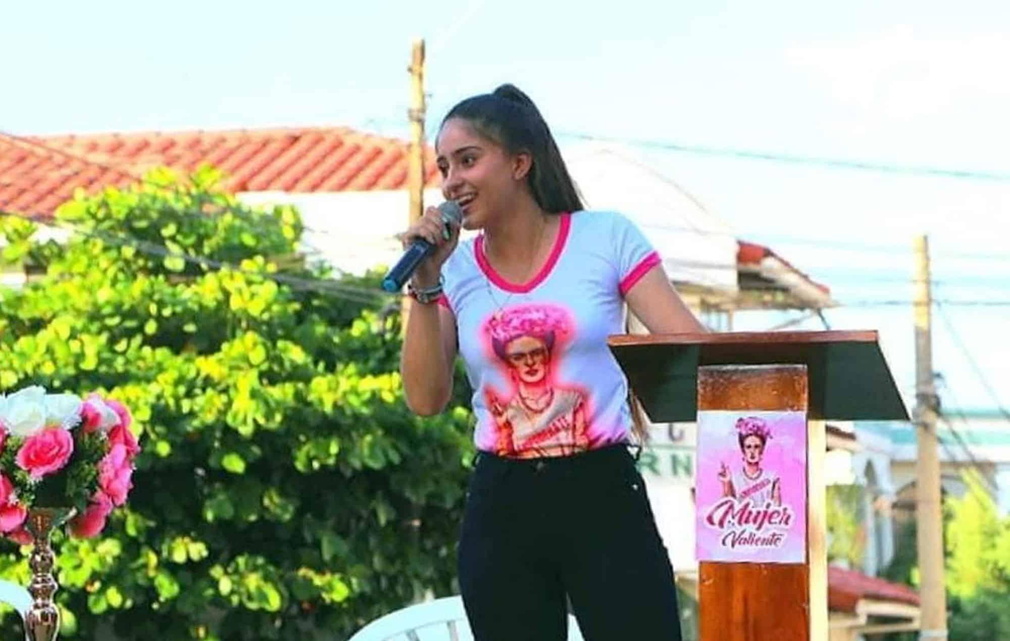 Maria, a girl in Bolivia, speaks on a microphone about girls can change the world and pursue their own dreams