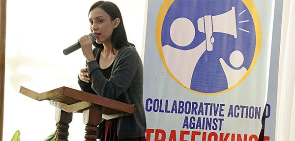 Carmella speaks at the podium on Collective Action Against Trafficking