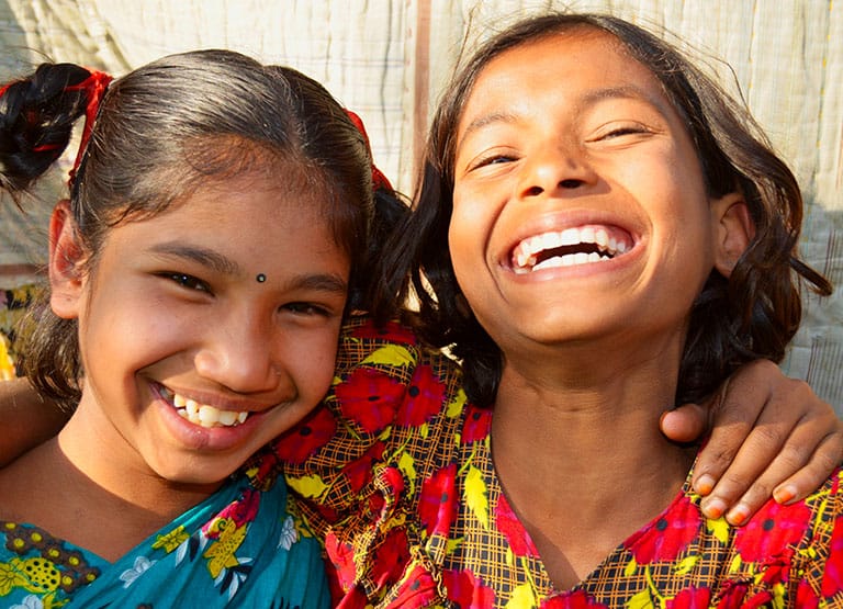 Two young girls laughing together