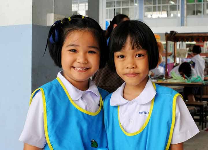 Two young girls in school uniforms