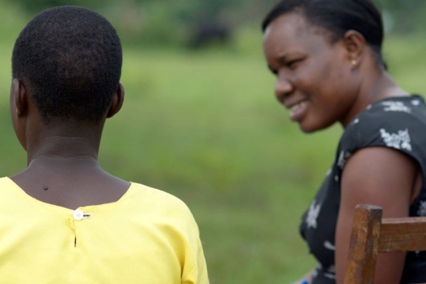 Two girls have a conversation in Uganda