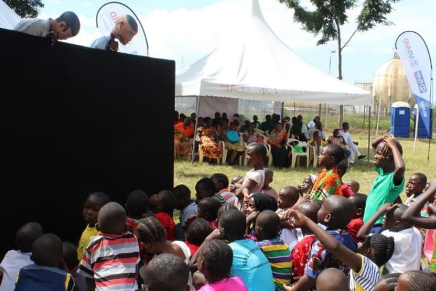 Children watch puppet show at the Mombasa curtain raiser