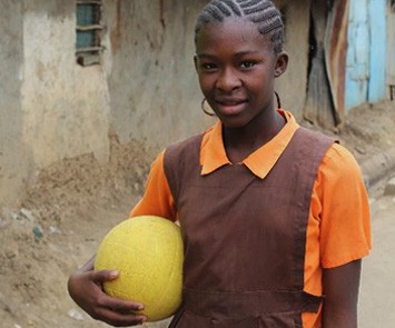 A girl from Kenya holding a ball