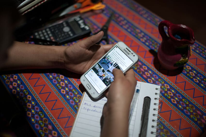 A person sees social media posts on a smartphone