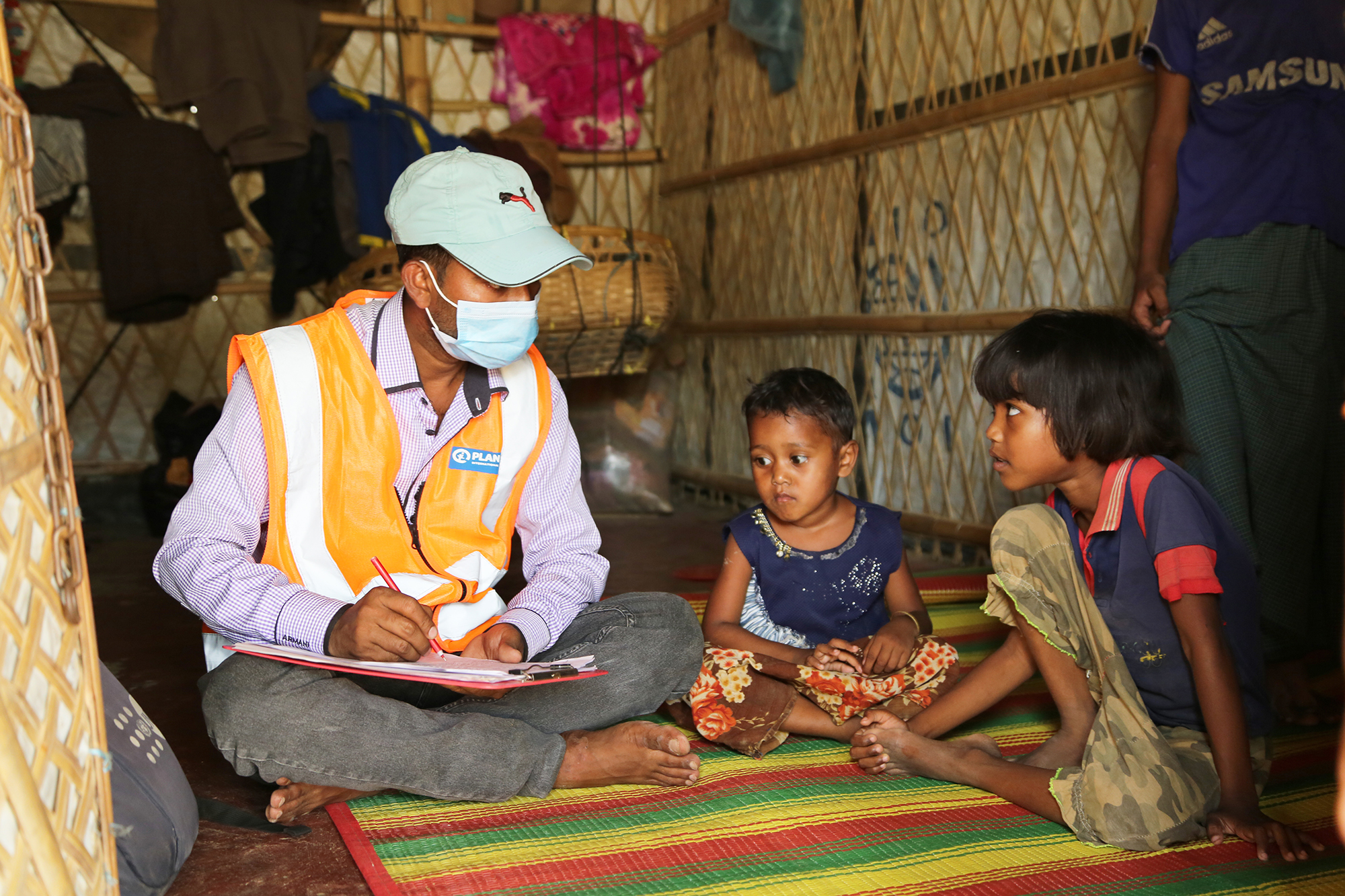 Plan International worker coordinating the reunion of lost Rohingya refugee children in Coxís Bazar with their parents.