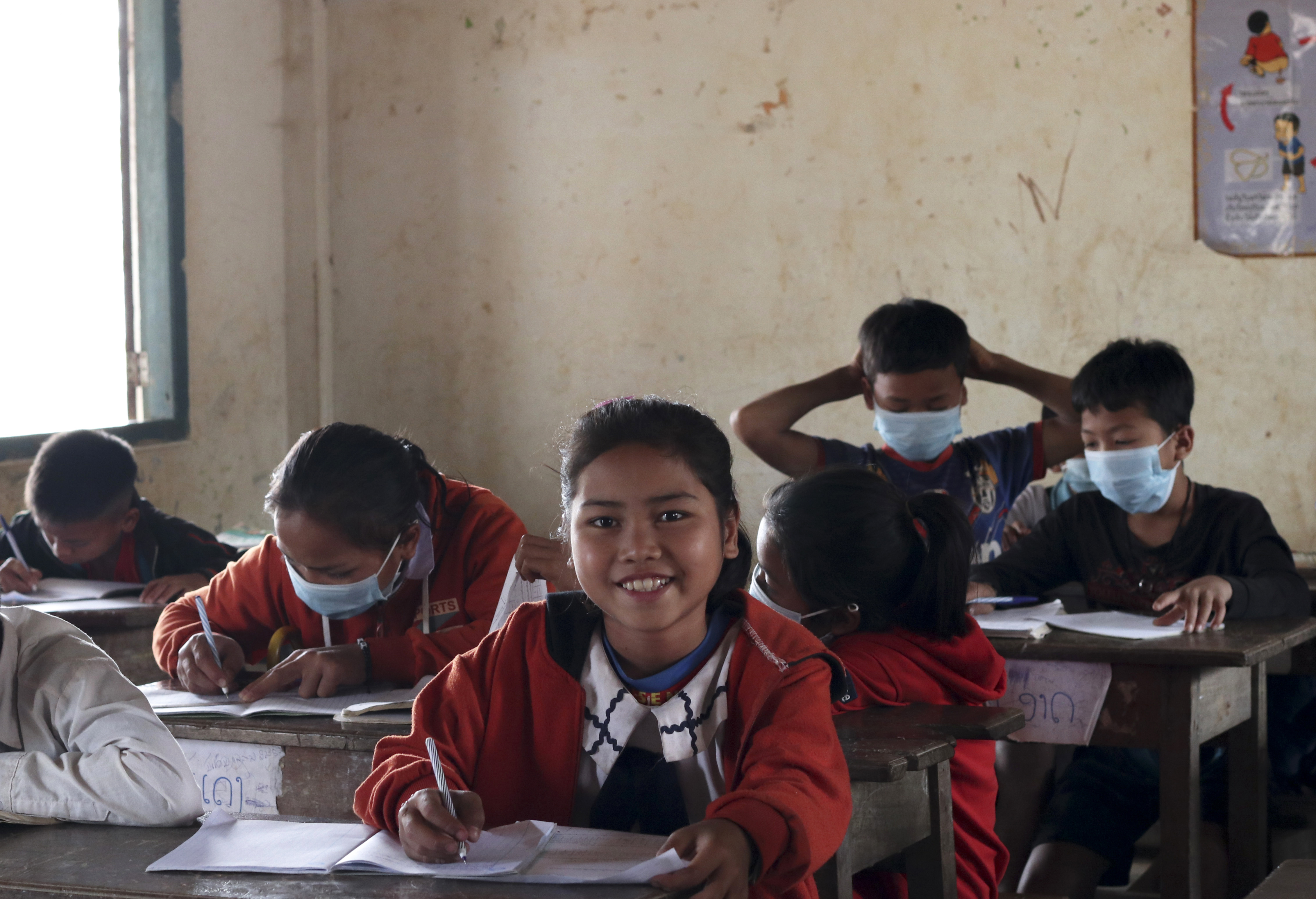 Sinxay, a 10 year old girl, supported by scholarship smiles in her classroom in Pha Oudom District