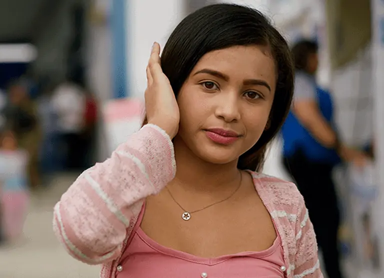 Young woman in pink; girls like her need you to be an advocate for girls rights and gender equality.