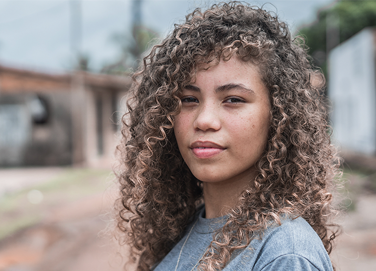Portrait of a curly haired girl looking at the camera