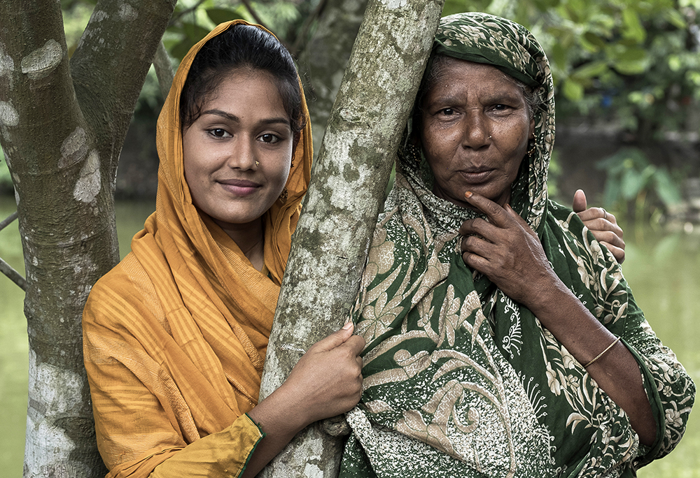 Tanzila with her grandmother near their home in Bangladesh. 