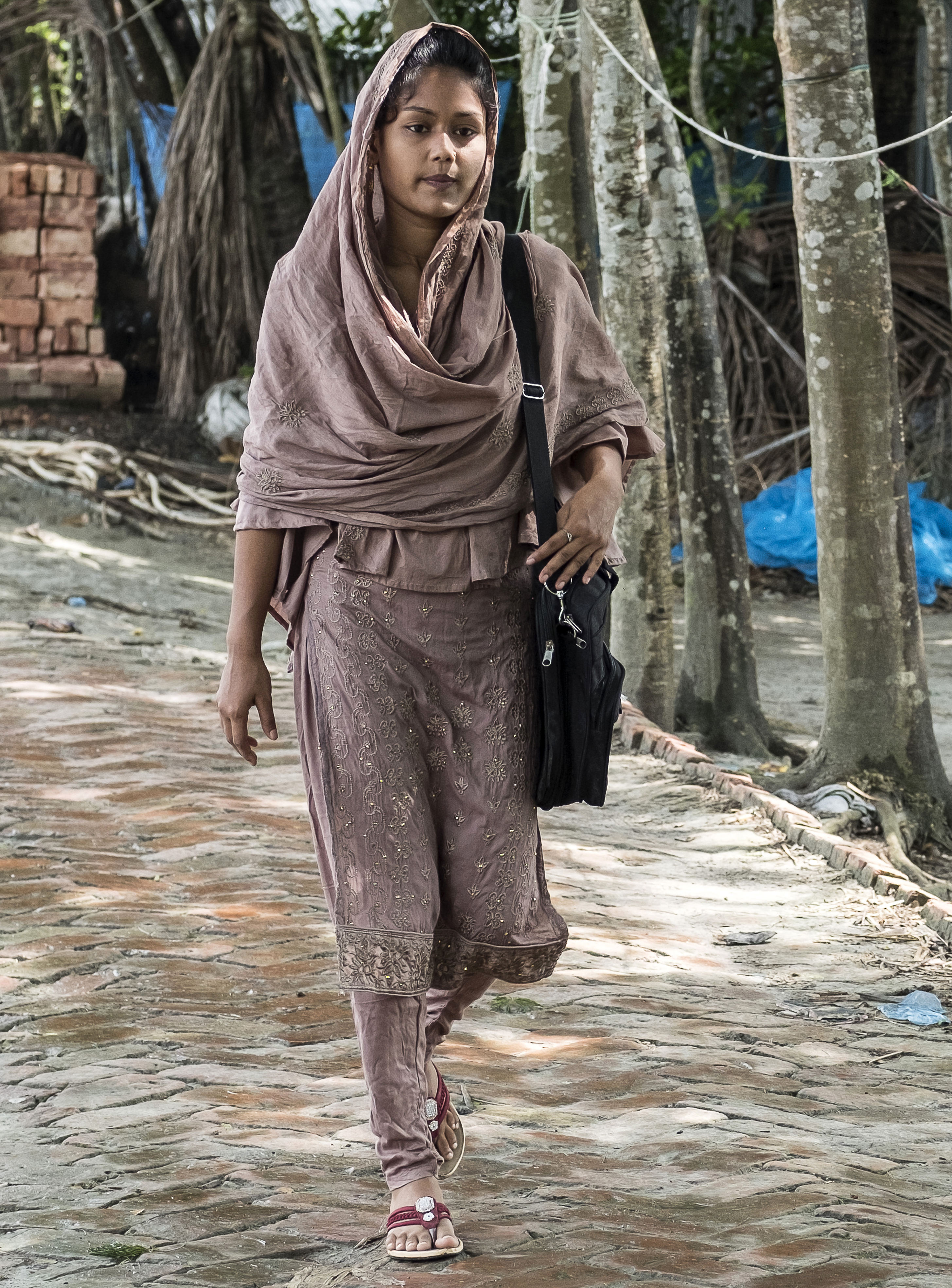 Tanzila, a young woman in Bangladesh, walks to school