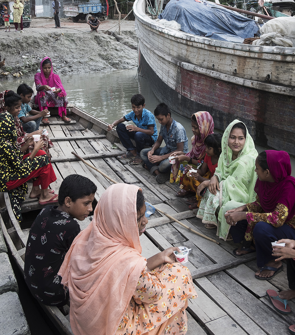 Tanzila and her students take a boat to reach the accelerated learning school. 