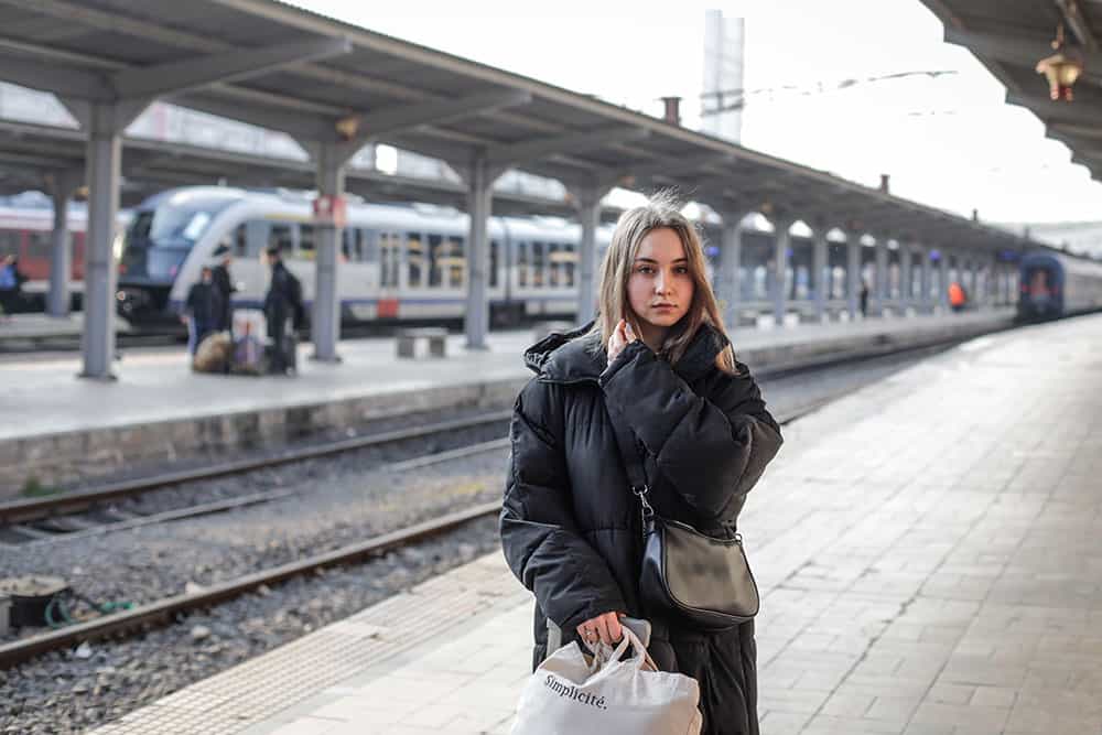 Katy, a Ukranian adolescent girl, waits in a train station in Bucharest, Romania, unsure what the future holds for her.