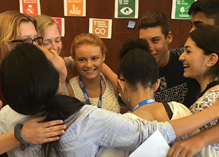 a group of young people hugging
