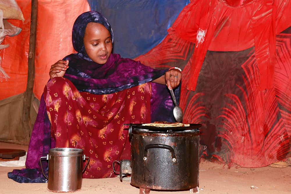 Najma cooks a small meal for her family.