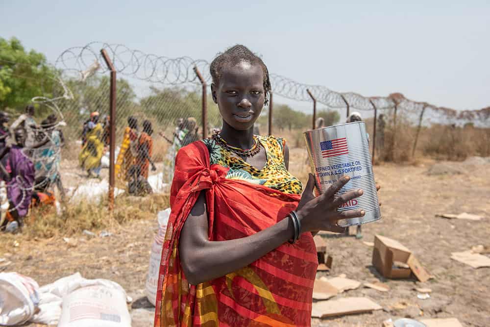 Adeng was forced to flee her home due to conflict while expecting her first child. Through funding from U.S. Agency for International Development, Plan provided resources for her and her family.