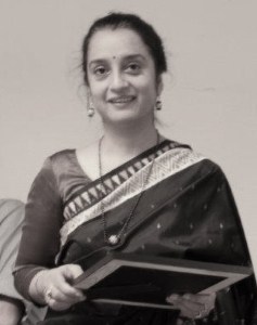 Varshita smiles as she receives an award for her contribution to the Department of Hydraulic and Environmental Engineering at the Norwegian University of Science and Technology.
