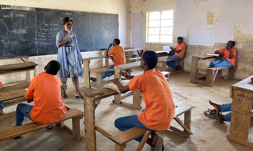 A headteacher in Kenya teaches a class which has no girls left, due to the gendered implications of the drought. 