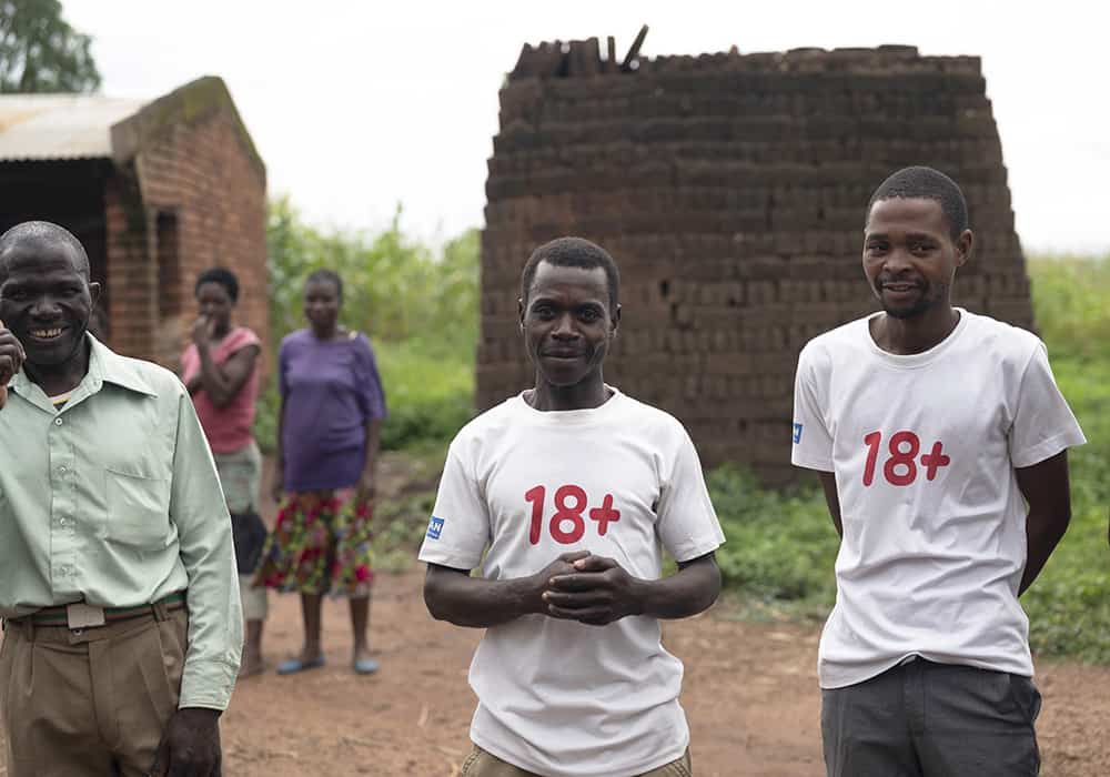 Male allies in Mulanje wear Plan “18+” shirts as a way to advocate against child marriage. 