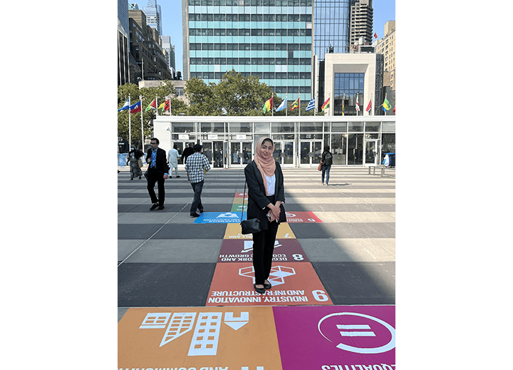 A young person posing in from of the UN | Plan International USA Youth Leadership Academy