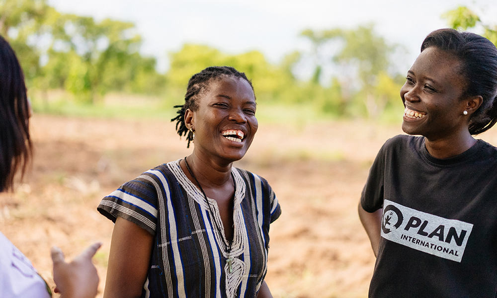 A Plan Ghana youth engagement facilitator, Abigail (right), with Christiana (left), a young pumpkin farmer in Ghana. 