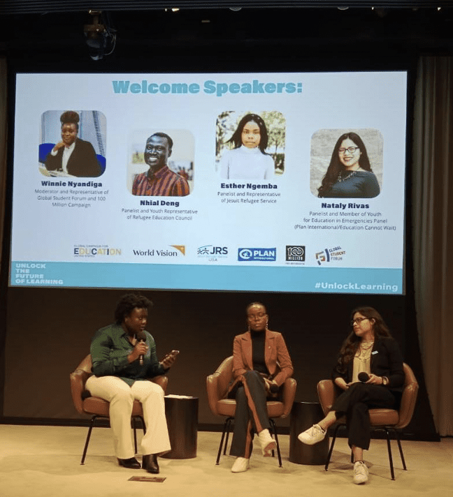 Nataly (right) sits on stage at the Unlock the Future event and prepares to present. 