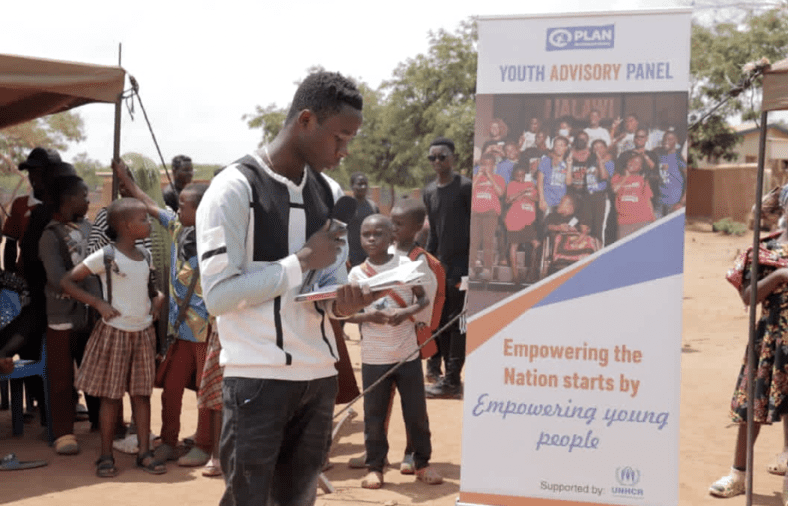 Damien speaking at the Dzaleka refugee settlement in Malawi. 