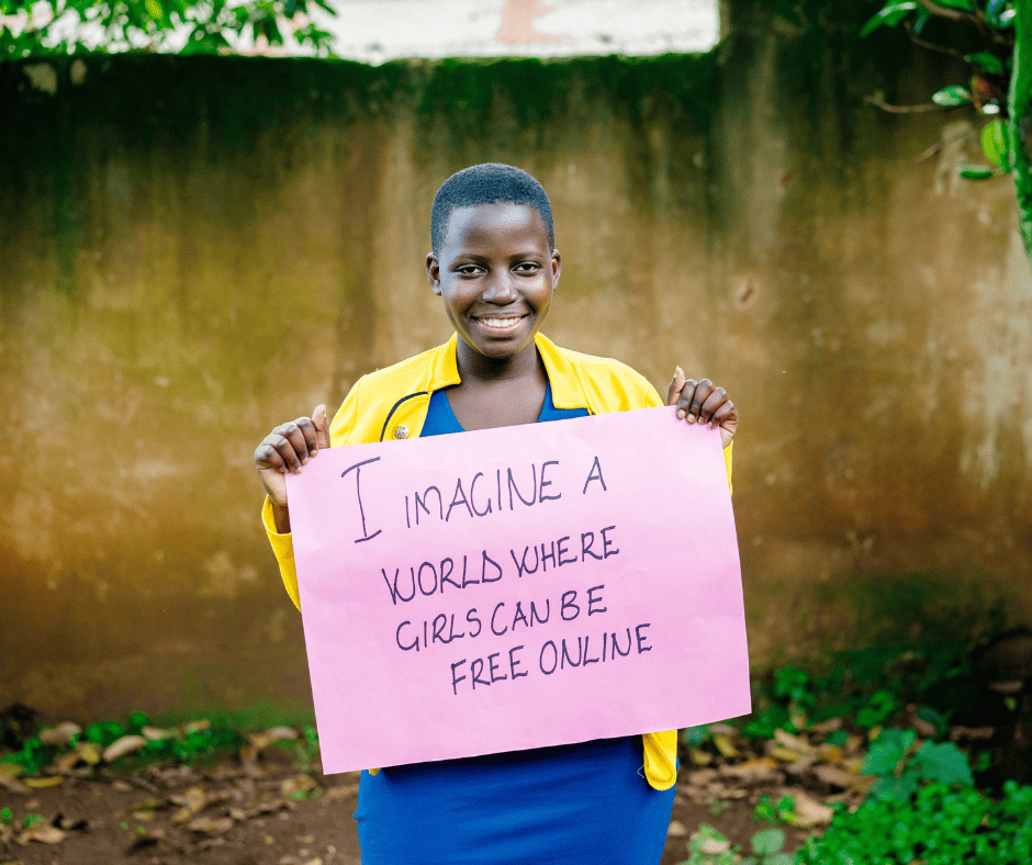 A young African woman holds a pink sign with a handwritten message reading, "I imagine a world where girls can be free online."