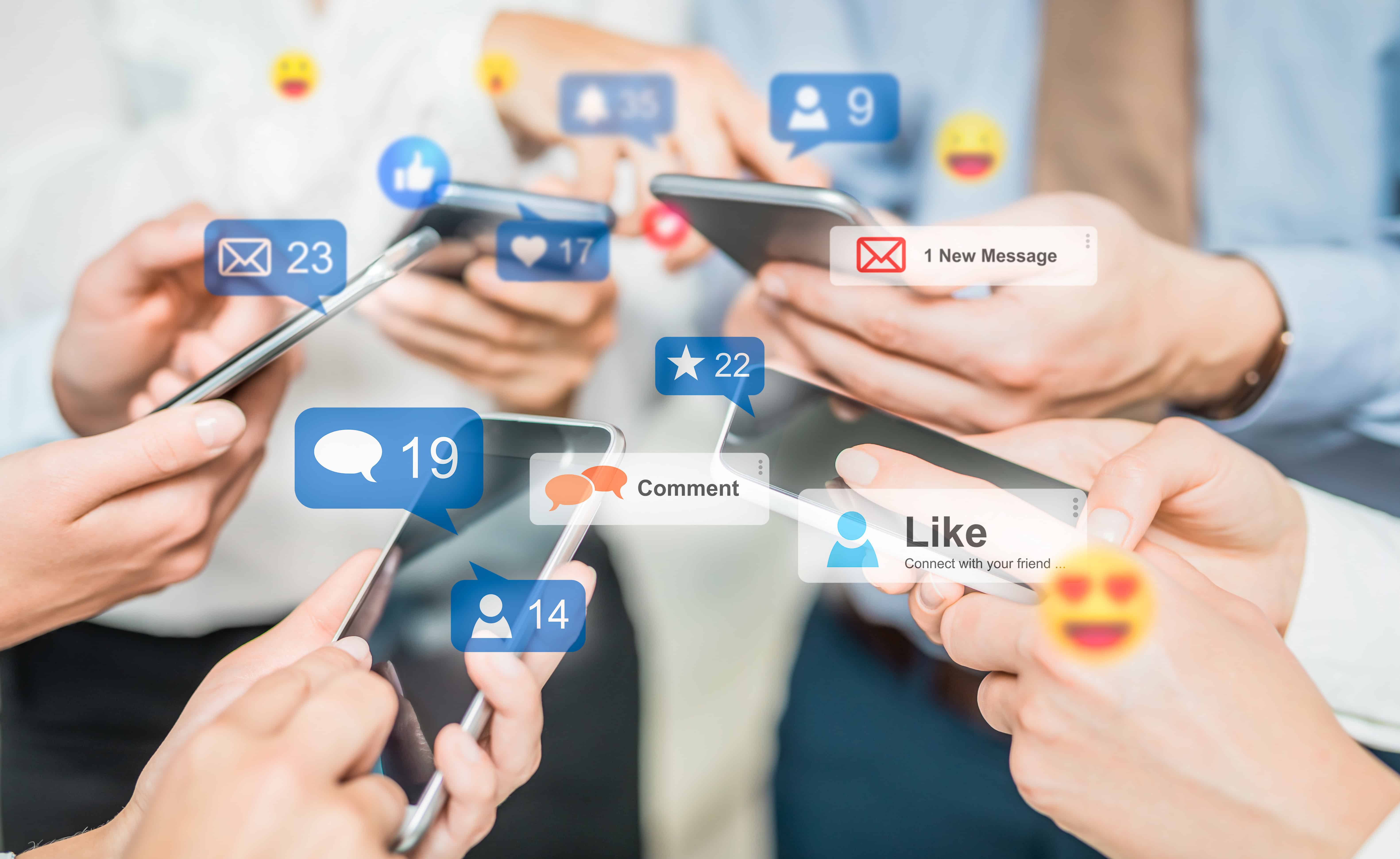 Multiple people using smartphones with comment bubbles, likes, and message icons floating above, representing social media interactions.