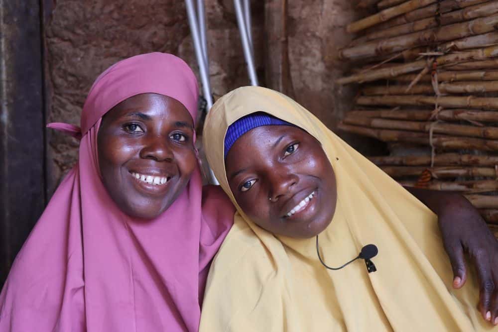 A mother and daughter smile for the camera.