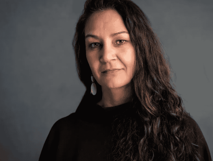 Portrait of Reena Ghelani, newly appointed Chief Executive Officer of Plan International, smiling confidently.