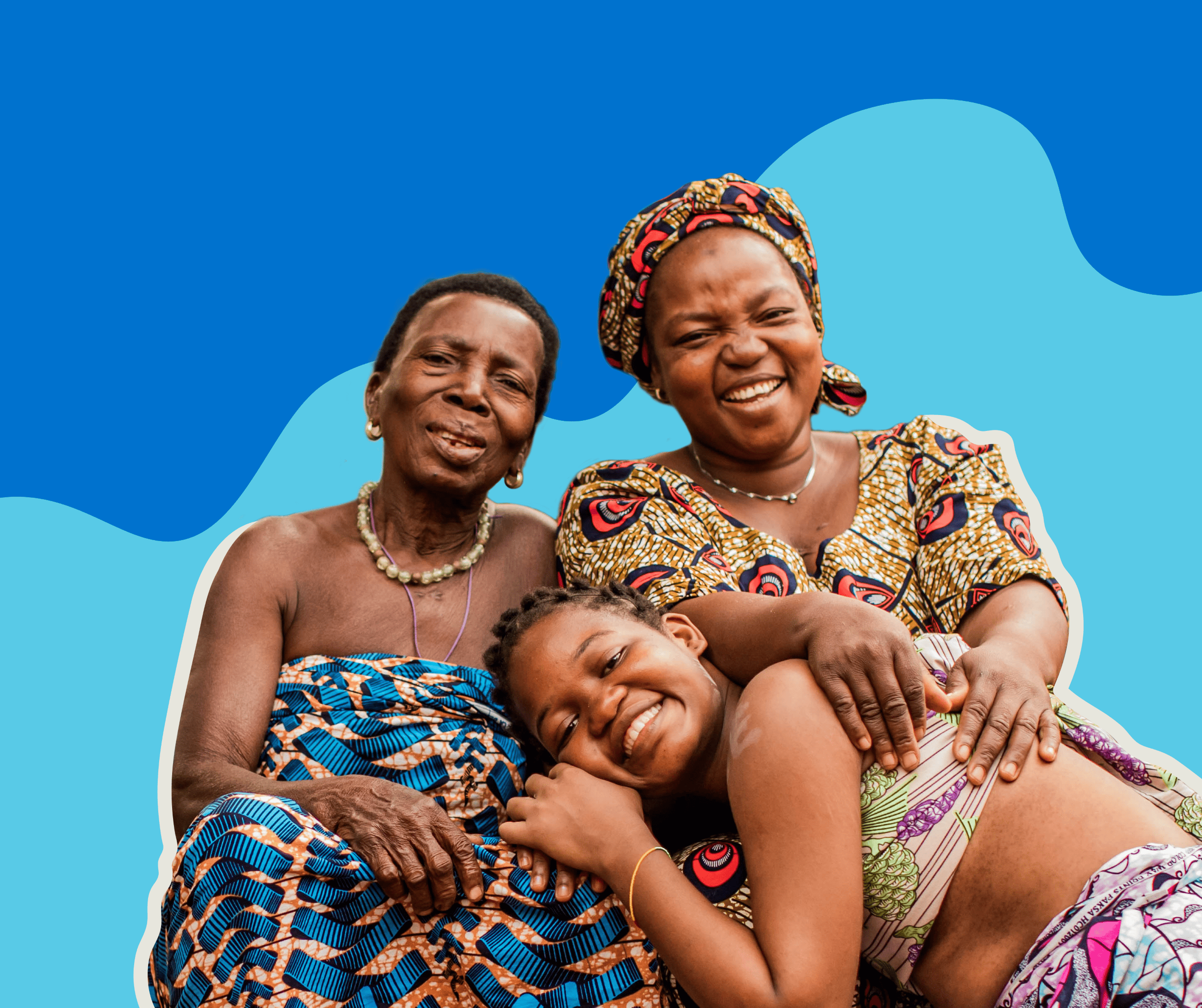 A grandmother, mother, and daughter embrace, smiling warmly. Their bond represents strength, leadership, and intergenerational support for girls’ education and empowerment. | © Plan International