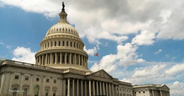 he U.S. Capitol building in Washington, D.C., under a partly cloudy sky.