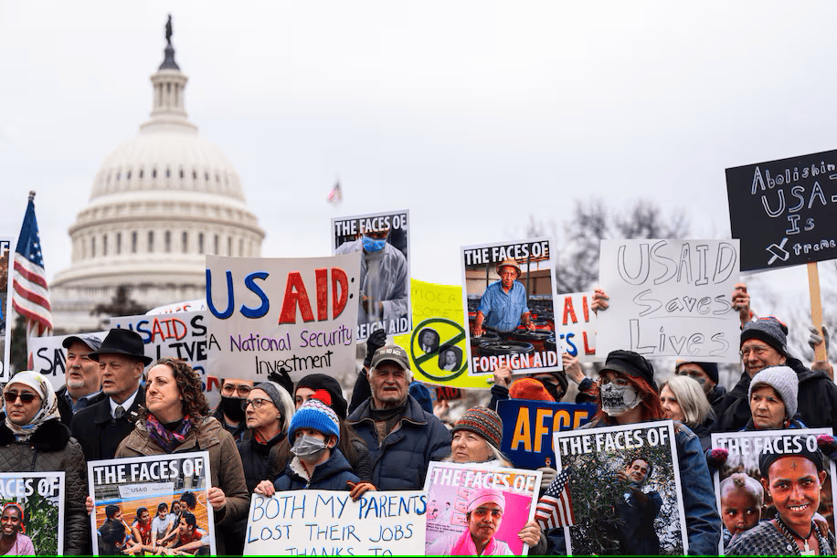 Protesters gather in front of the U.S. Capitol holding signs supporting USAID and foreign aid, opposing the Trump administration's decision to shut down the agency.